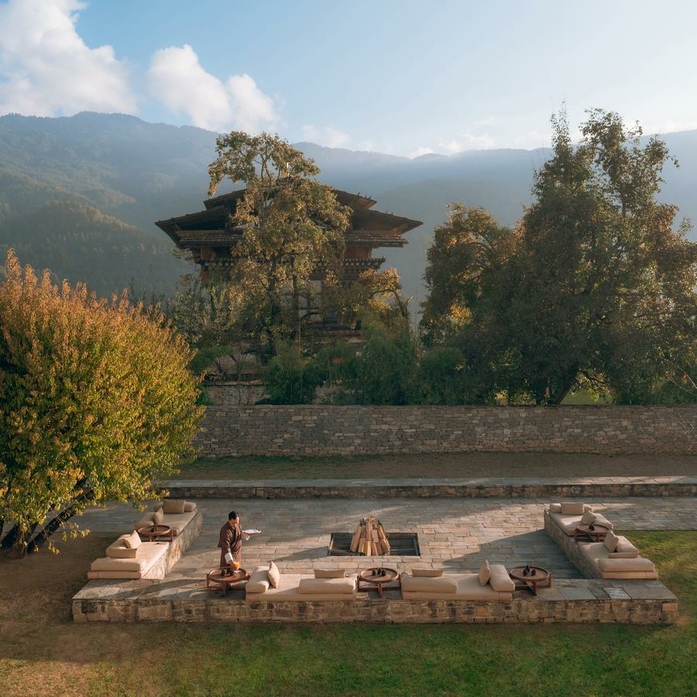 Outdoor firepit lounge at Amankora Bhutan with Himalayan mountains