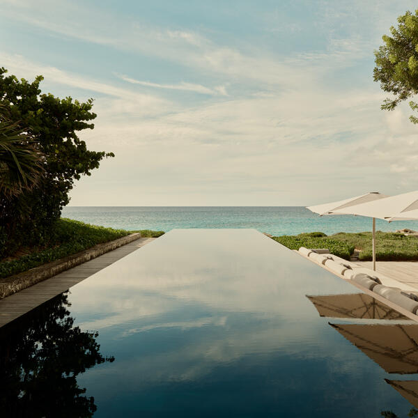 Infinity pool overlooking turquoise Caribbean waters at Amanyara villa